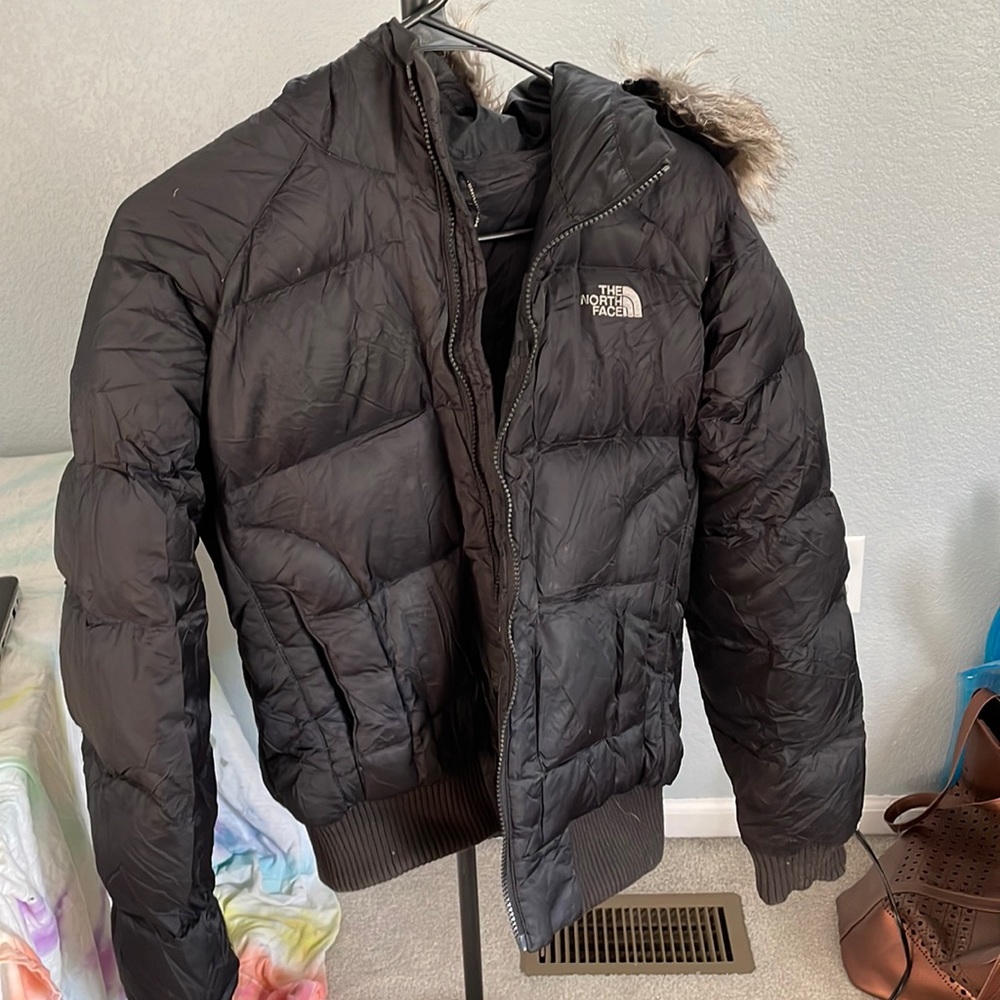 Black North Face puffy jacket.